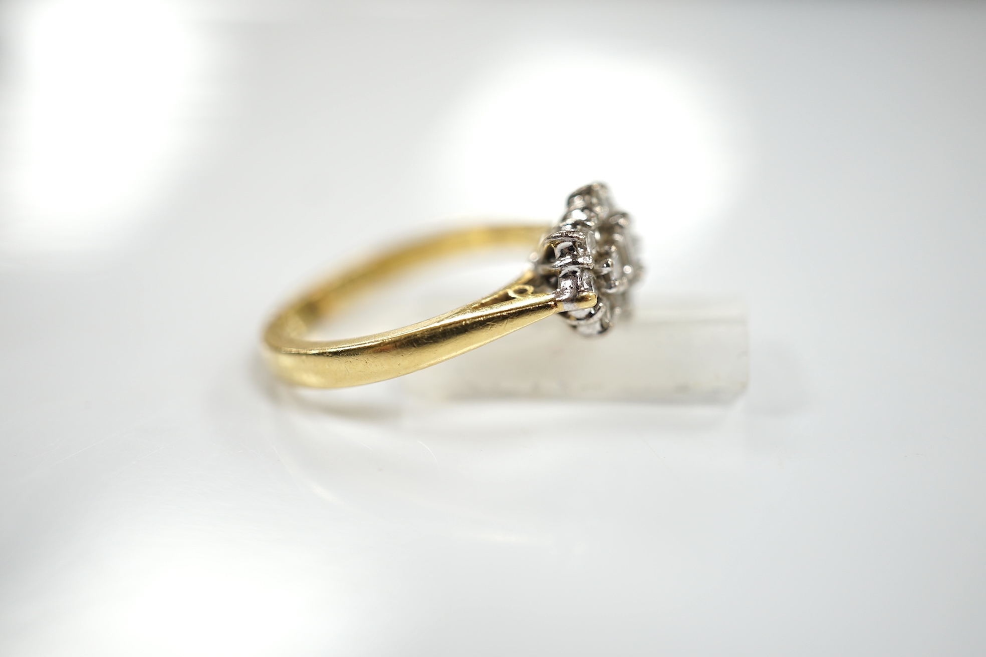 A modern 18ct gold and diamond cluster ring, size K, gross weight 4.4 grams. Condition - fair to good